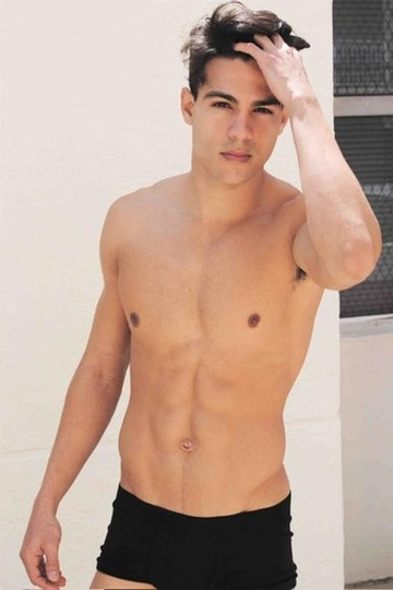 Ray Diaz first modeling polaroid, standing against a white wall