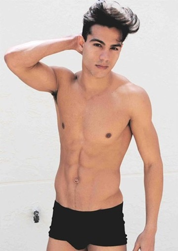 Ray Diaz modeling polaroid, front pose against a white wall