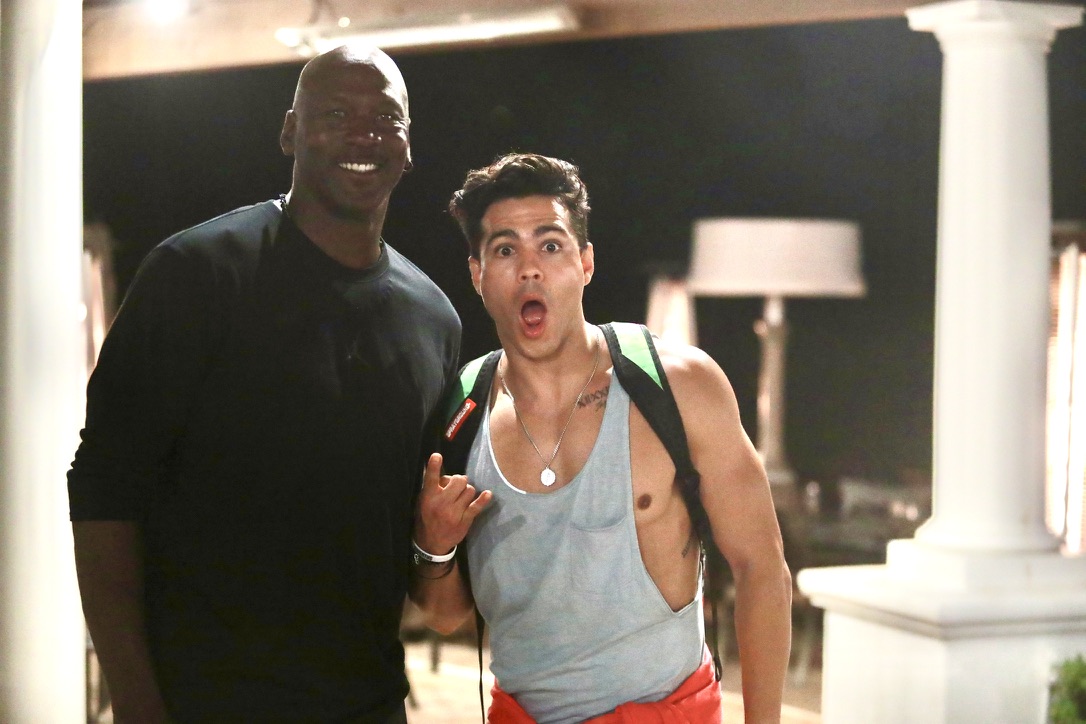 Ray Diaz taking a photo with Michael Jordan at night
