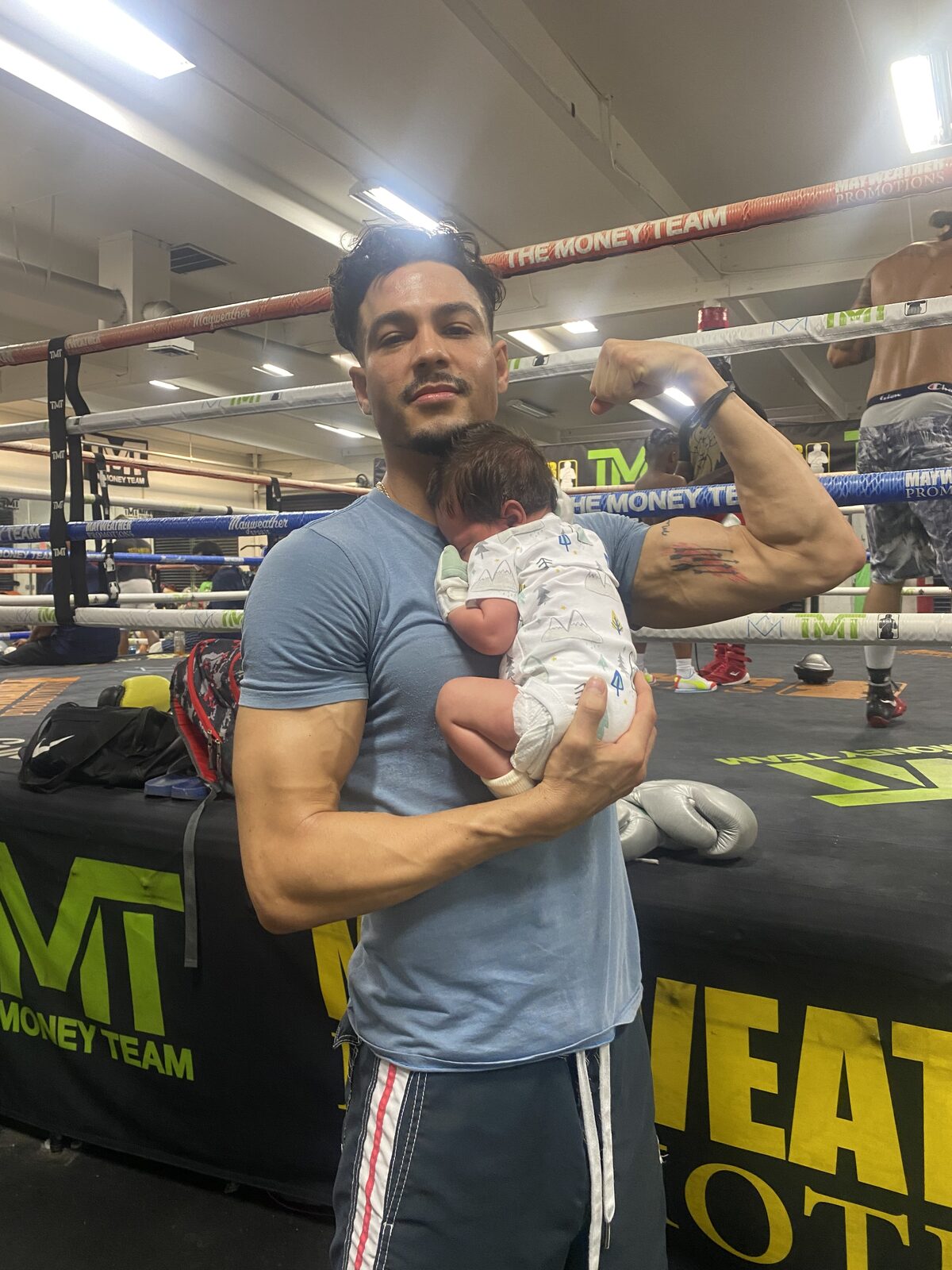 Ray Diaz holding his newborn son inside Floyd Mayweather's TMT gym in Las Vegas, August 2023